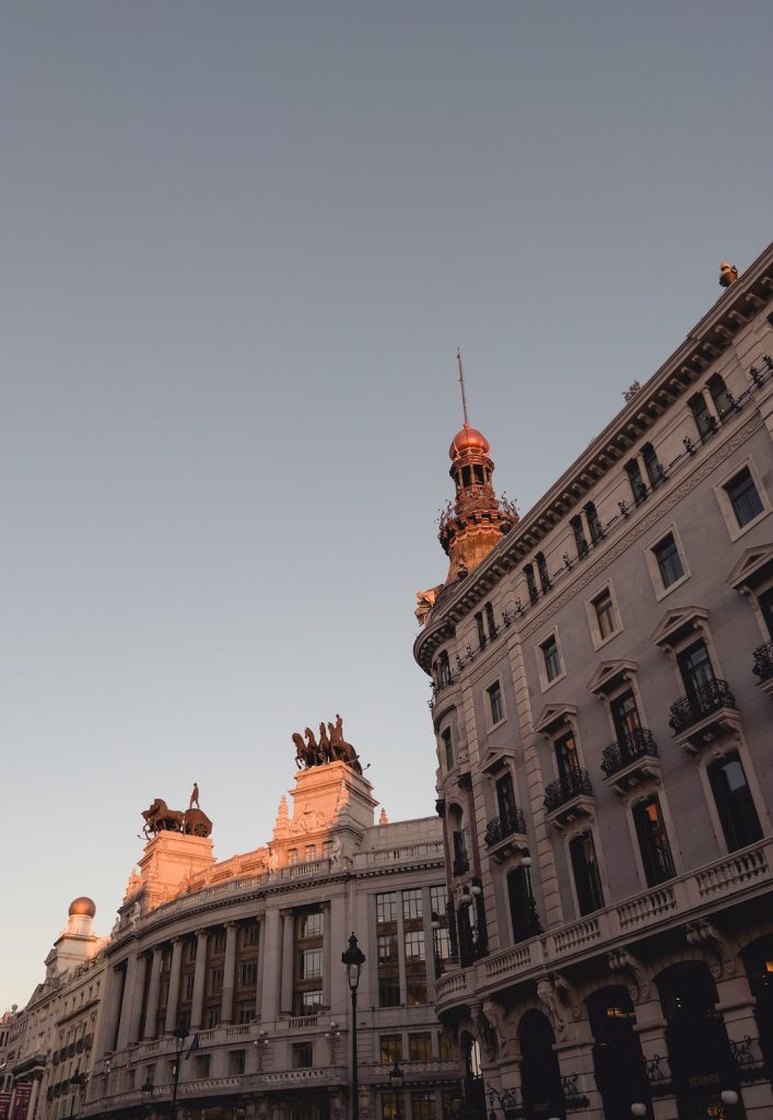 The Art of Drawing Readers In: Your attractive post title goes here Banco de Bilbao and Four Seasons Hotels rooftop sculptures in sunset, in Madrid, Spain.