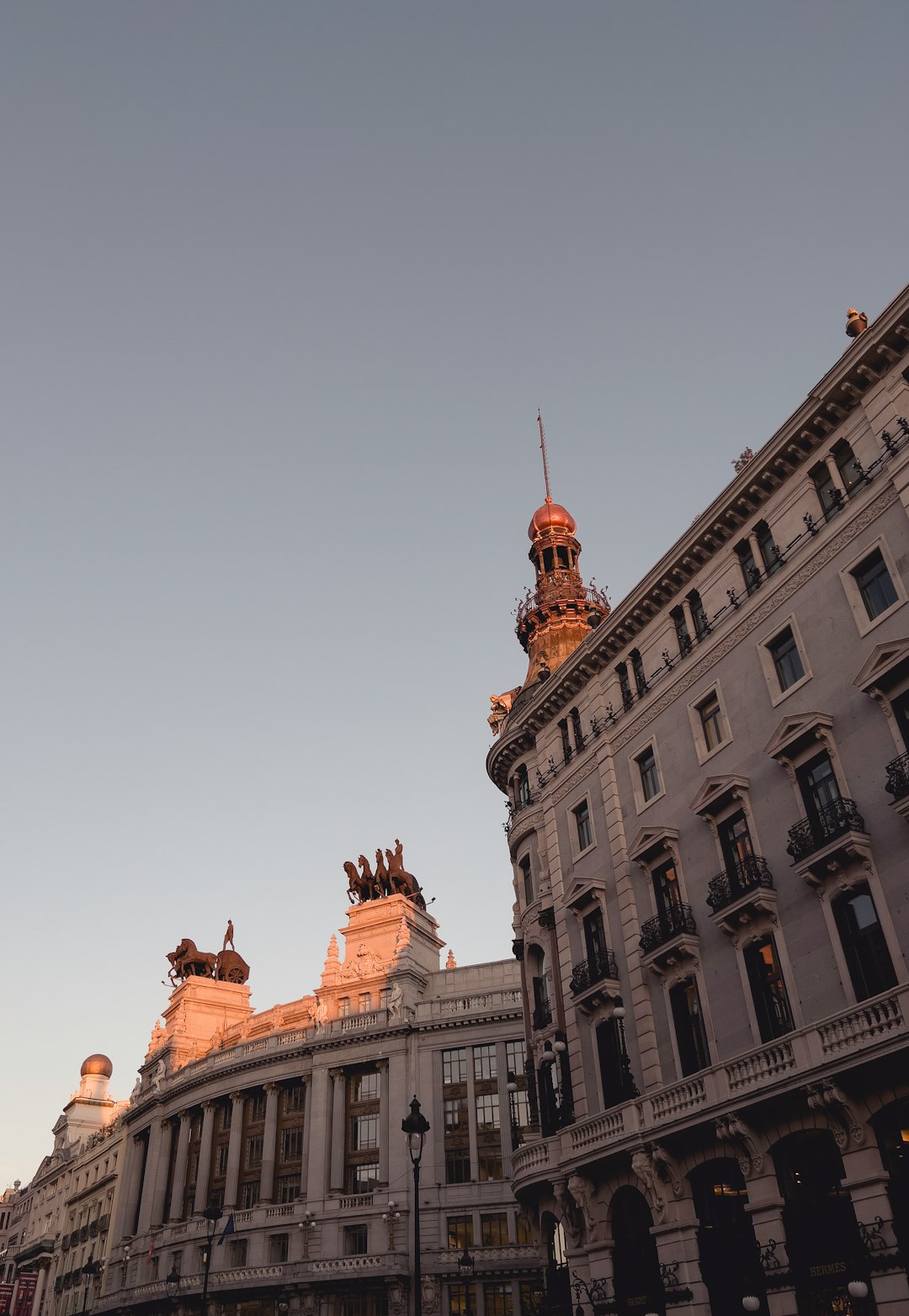 Banco de Bilbao and Four Seasons Hotels rooftop sculptures in sunset, in Madrid, Spain.